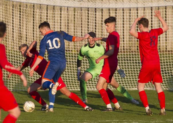 Taylor Hope rattles the ball into the bottom left corner of the net for Hawick Royal Albert United against Heriot-Watt University. Photo: Bill McBurnie
