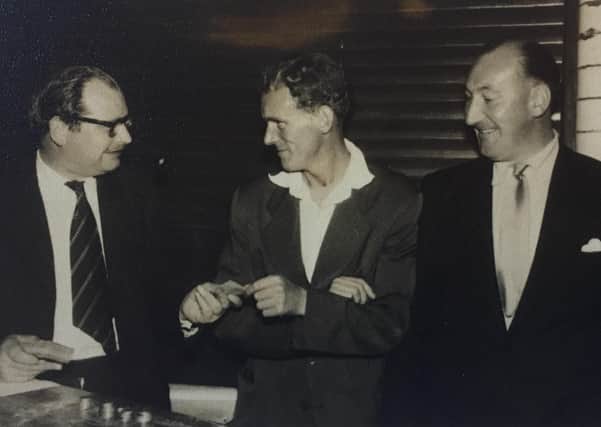 Duncan Mackinnon, left, doing what he did best, selling tickets. Can anyone name the other two gentlemen?
