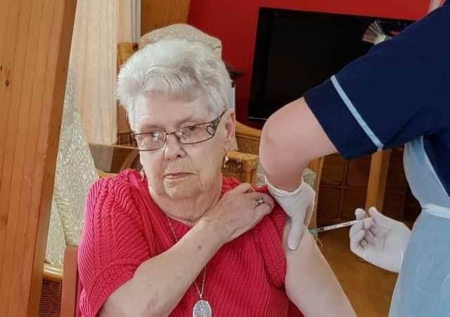 Ann Slater, who lives at St Ronan's Care Home in Innerleithen, receives her vaccine.