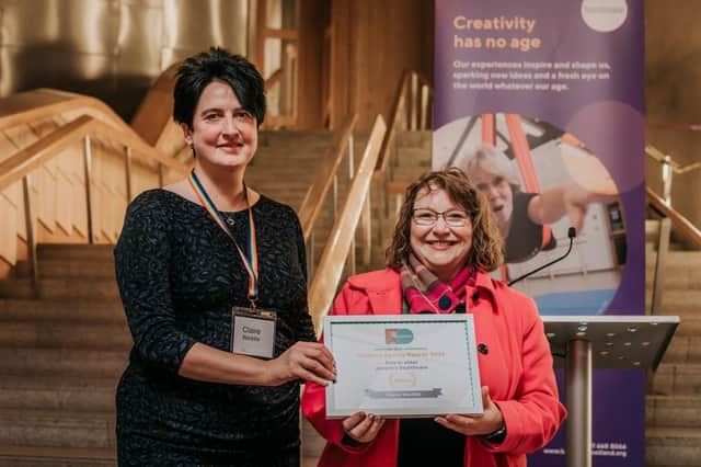 Claire Weddle receives the Arts In Older People’s Healthcare award from Clare Adamson, MSP. Photo: Mihaela Bodlovic.