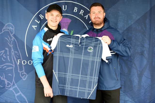 South of Scotland champion at Duns, Ali Dick, left, is presented with his international footgolf top by Scotland captain Joe McCourt.