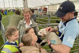 Pupils, and Councillor Carol Hamilton, get up close and personal with a wee lamb. Photos: SBC.