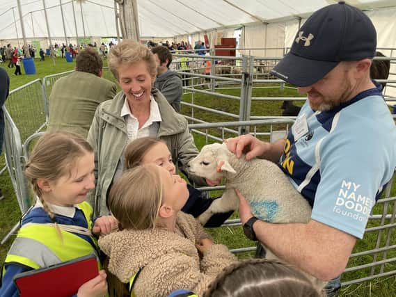 Pupils, and Councillor Carol Hamilton, get up close and personal with a wee lamb. Photos: SBC.