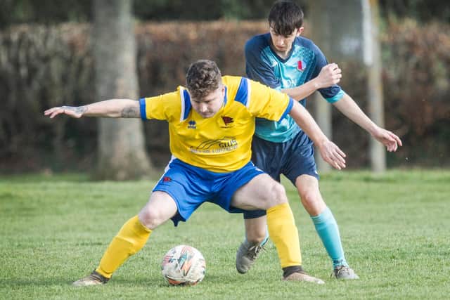 Hawick Colts' Aaron Swailes shielding the ball from Kieron Butler at St Boswells (Photo: Bill McBurnie)