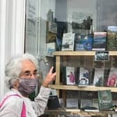 Carol Beveridge points to the book in a bookshop window.