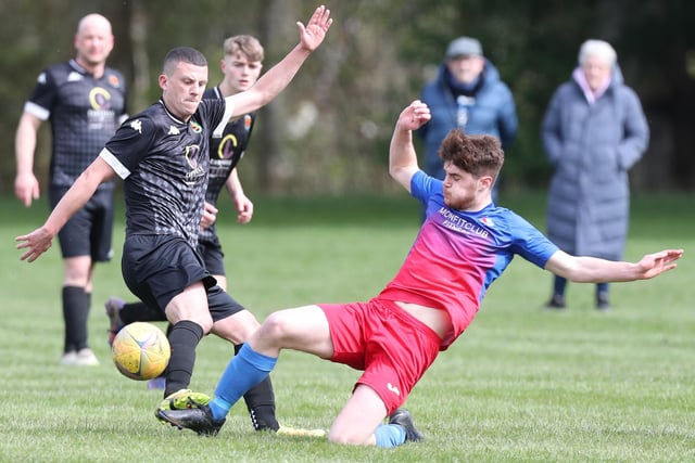 Ross Moffat slide-tackling Hawicks Gavin Tait during Hawick United's 4-2 win at home at Wilton Lodge Park on Saturday to St Boswells in the Border Amateur Football Association's B division (Photo: Brian Sutherland)