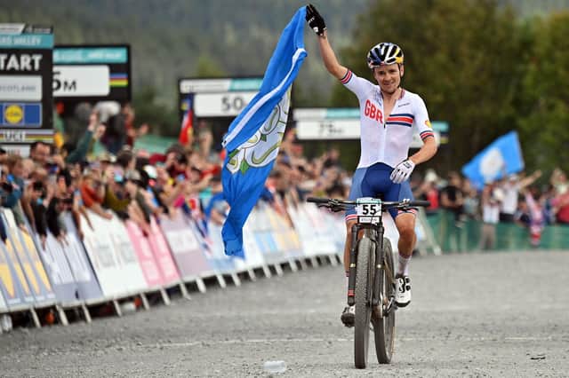 Great Britain's Tom Pidcock celebrating winning the men's elite cross-country Olympic mountain bike race during this year's UCI world championships at Glentress Forest on Saturday (Photo by Andy Buchanan/AFP via Getty Images)
