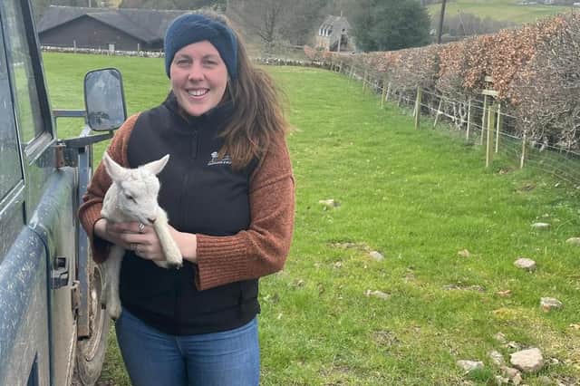 Jasmine Jackson on the farm with one of the lambs.