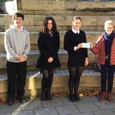 George Wilson and Edith Scott hand over the cheque for £900 to the school's present day pupils.