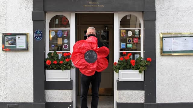 Owner Nick Henderson from the Burts Hotel in Melrose with their poppy. Photo: Douglas Hardie.