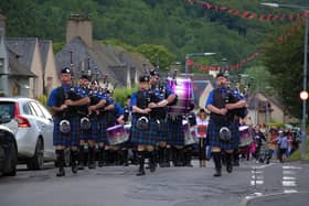 The pipe band leads the fancy dressers on Friday night's parade. Photos: Devon Leslie.