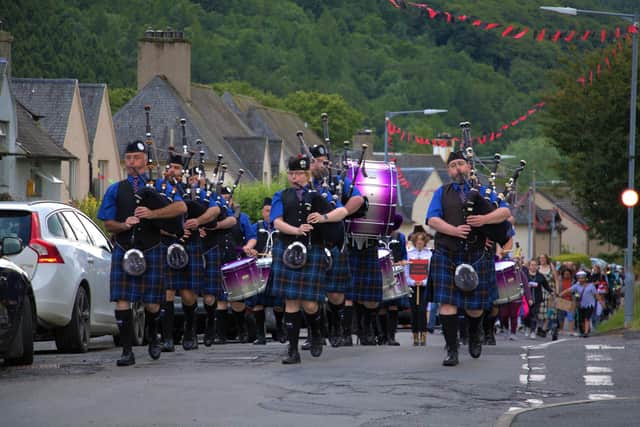 The pipe band leads the fancy dressers on Friday night's parade. Photos: Devon Leslie.