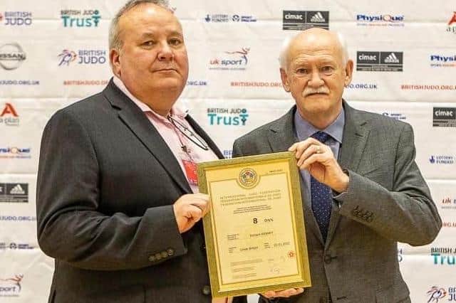 Rick Kenney being presented with his judo eighth-dan diploma by Ronnie Saez, chairman of the British Judo Association, in Sheffield