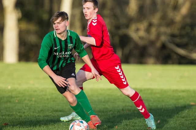 Callum Murray, in Hawick Legion's black and green, edges ahead of Kelso Thistle's Lee Hogg