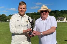 Hawick cricket captain Euan Hair, left, receives the Ronnie Simpson Memorial Trophy from Selkirk CC chairman Roger Arnold.