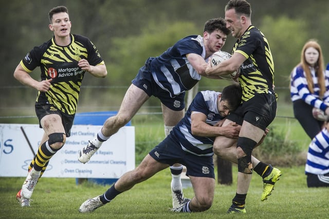 Selkirk captain Aaron McColm and team-mate Ryan Cotty challenging Melrose's James Brown at Earlston Sevens
