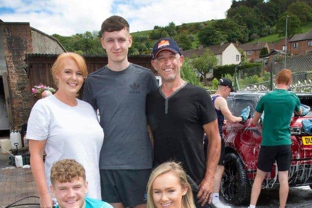 The rest of the Graham family at a fundraising event at the car wash in June.  Mum Leah, Clark, dad Ali, Darcy and Rhianna. (Photo: BILL McBURNIE)