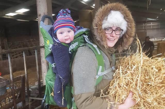 Victoria Ivinson, pictured with her baby son Wilfred on the family's farm in Cumbria.