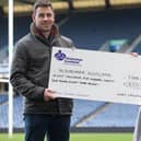 Rugby coach Chris Laidlaw handing over a cheque for £8,525 to Alzheimer Scotland's Sarah Cheung at Edinburgh's Murrayfield Stadium this week (Photo by Craig Williamson/SNS Group/SRU)