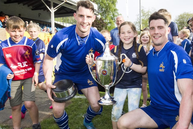 Roddy and May Rutherford celebrating with Jed-Forest's Young brothers, Gregor and Lewis, at their club's 2022 sevens tournament