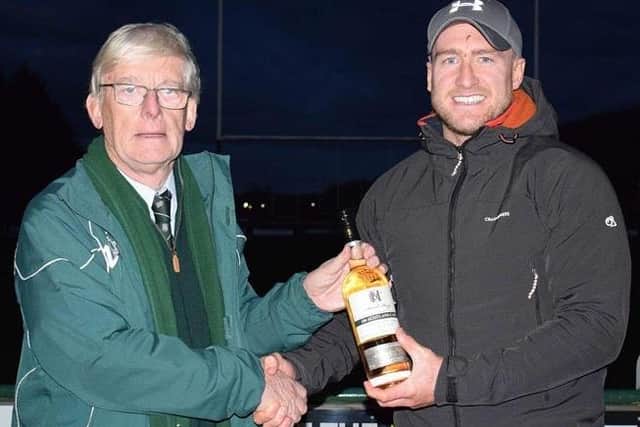 Hawick club president Ian Landles presenting former Green Stuart Hogg with a bottle of whisky in March in celebration of his 100th Scotland cap (Pic: Hawick RFC)