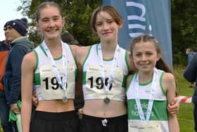 From left, Evie Leonard, Molly Trewartha and Rose Davidson at Saturday’s 2026 Scottish east district cross-country relays at Livingston (Photo: Neil Renton)