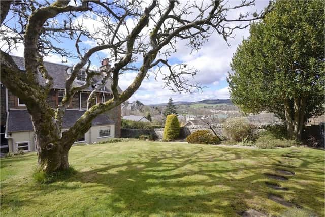 The property's beautiful garden offers striking views across the valley.
