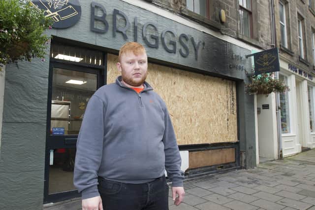 Jedburgh butcher, Ryan Briggs outside his shop which has been damaged by an arson attack. Photo: Bill McBurnie.