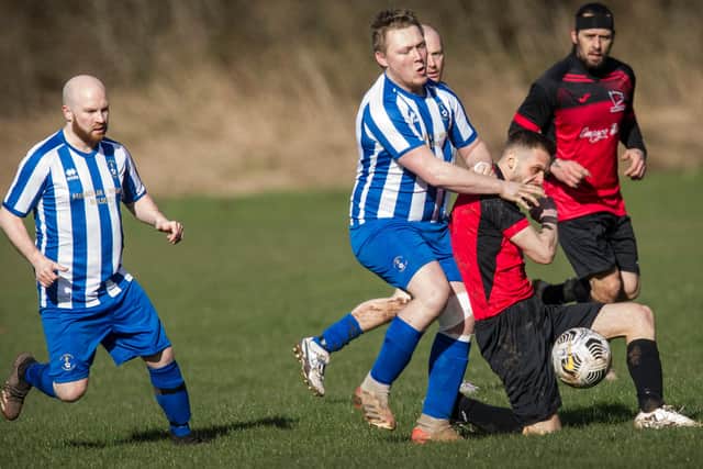 Hawick Colts goal-scorer Nathan Gillie being tackled by Jed Legion's Stephen Davidson (Photo: Bill McBurnie)