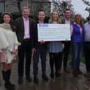 Young farmers present the cheque to George's parents.