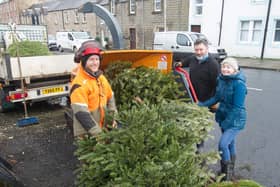 Chris Anthony and Gordon Campbell take a Christmas tree from Michelle Smith for a small donation to Denholm Primary School. (Photo: BILL McBURNIE)