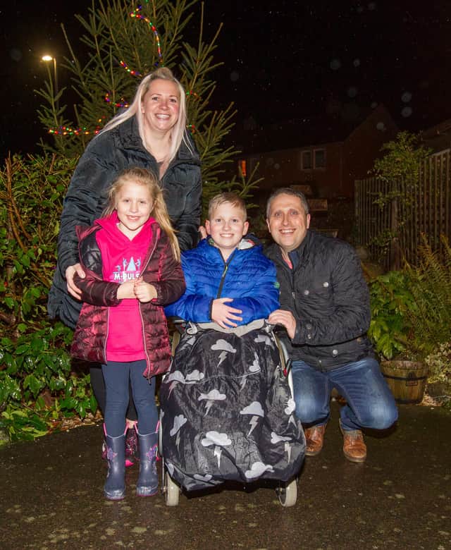 Eight-year-old year old Lukas Thomsom swithced on Ednam's Village Hall Christmas tree lights. With mum Michelle, dad Martin and sister Mia. (Photo: BILL McBURNIE)