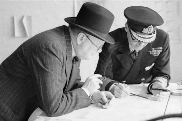 Winston Churchill and Bertram Ramsay look at a map of Channel defenses in 1940.