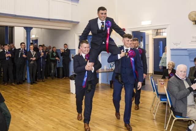 Gregor Paxton carried aloft by his left hand man Nick Arnold and right hand man Euan Munro with Rob Reid his Herald for a reception in the Town Hall. Photo: Bill McBurnie.