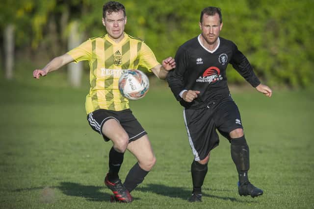 Michael Turnbull, right, in action for Langlee Amateurs during their 2-2 draw at home to Langholm Legion last Thursday night (Photo: Bill McBurnie)
