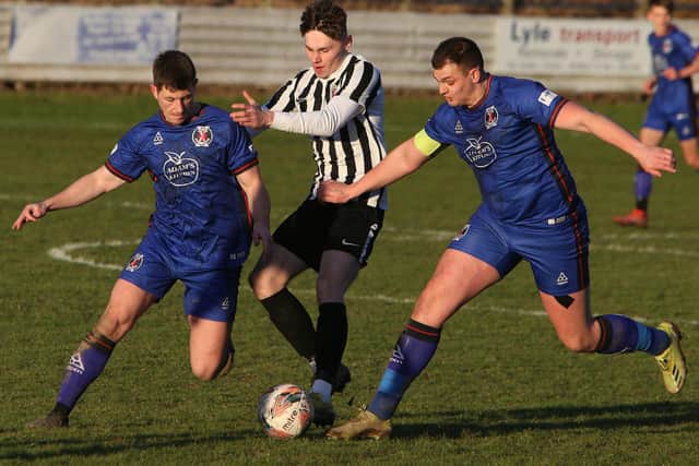Daniel Chandler, left, and captain Andy Common vying for possession for Hawick Royal Albert against St Andrews United on Saturday (Pic: Steve Cox)