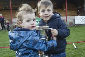 Rory Shirra-Gibb and Alex Gillespie keeping the cup safe for their dads at Langholm Sevens on Saturday
