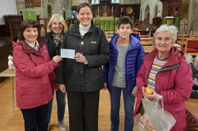 Nikki Porter presents the cheque to Galashiels Foodbank's Shirley Sandison, watched by volunteers Grace Murray, Murielle Johnson and Margaret Blyth.​​​​​​​