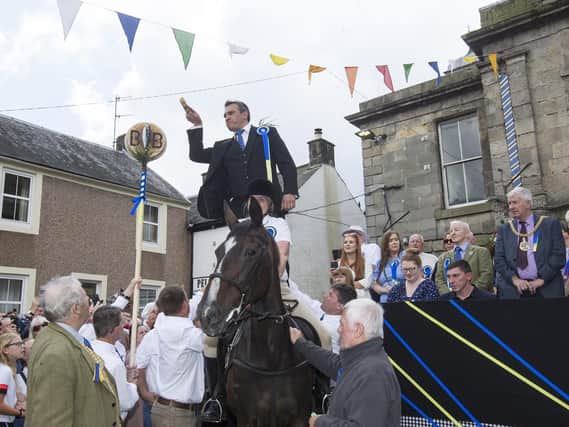 Fair Cryer Rae Elliot addresses the packed crowd at Langholm. All photos: Bill McBurnie.