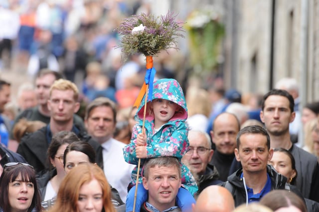 A delighted youngster carries a Heather Besom.