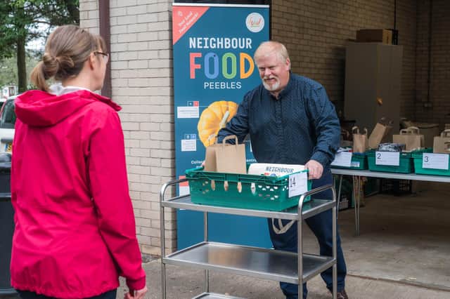 Robin Tatler, of The Food Foundation in Peebles, serving a customer.