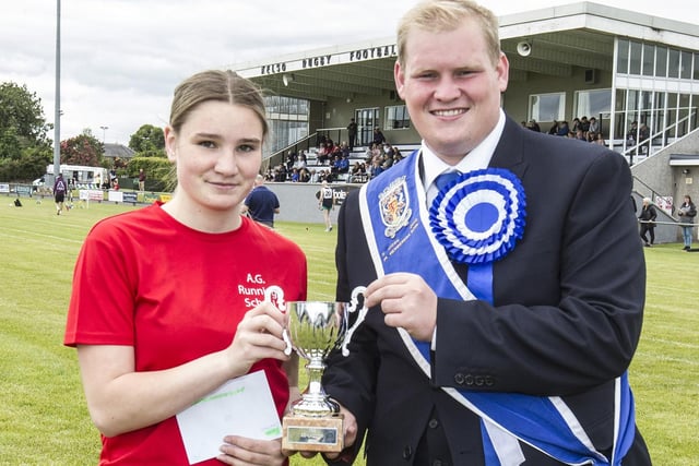 Ruby Laing being given her prize for one of her two 100m youth race wins by 2022 Kelso Laddie Callum Davidson