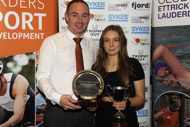 Isla Paterson being presented with her Club Sport Ettrick and Lauderdale award for junior sports personality of the year by Graeme Murdoch