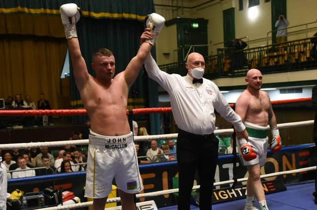 A victory salute from John McCallum, with opponent Lewis van Poetsch, right (picture by Philip Sharkey)