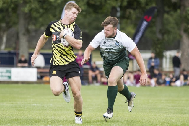 Melrose's Ross McConnell being chased by Hawick's Andrew Mitchell in their pool game at Peebles Sevens