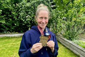 Anna Rutherford with her medal for completing a 100-mile ultra from Bamburgh to Edinburgh at the weekend (Pic: Neil Rutherford/SWNS)