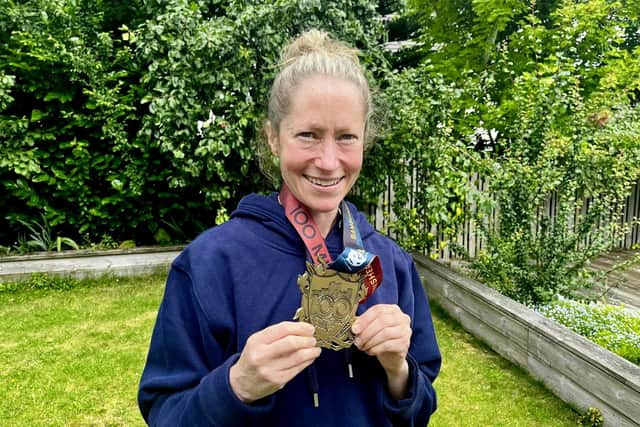 Anna Rutherford with her medal for completing a 100-mile ultra from Bamburgh to Edinburgh at the weekend (Pic: Neil Rutherford/SWNS)