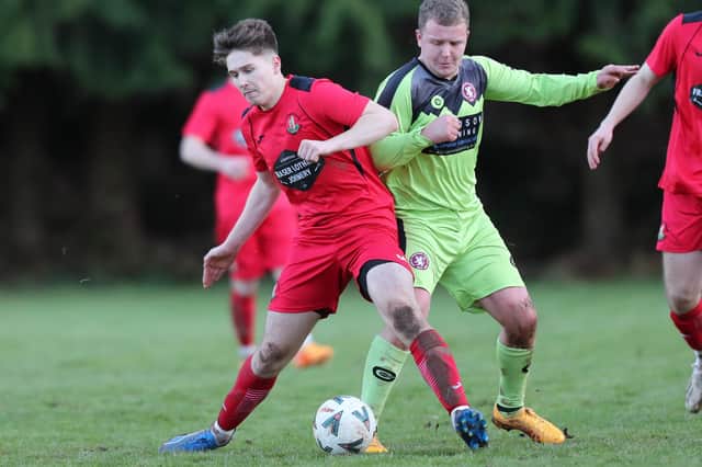 Earlston Rhymers' David Brown shielding the ball  from Langlee Amateurs' Tyler Smith at Runciman Park on Saturday (Photo: Brian Sutherland)