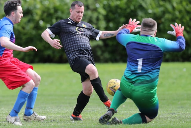 Kevin Strathdee going up against goalkeeper Andrew Kirk during Hawick United's 4-2 win at home at Wilton Lodge Park on Saturday to St Boswells in the Border Amateur Football Association's B division (Photo: Brian Sutherland)