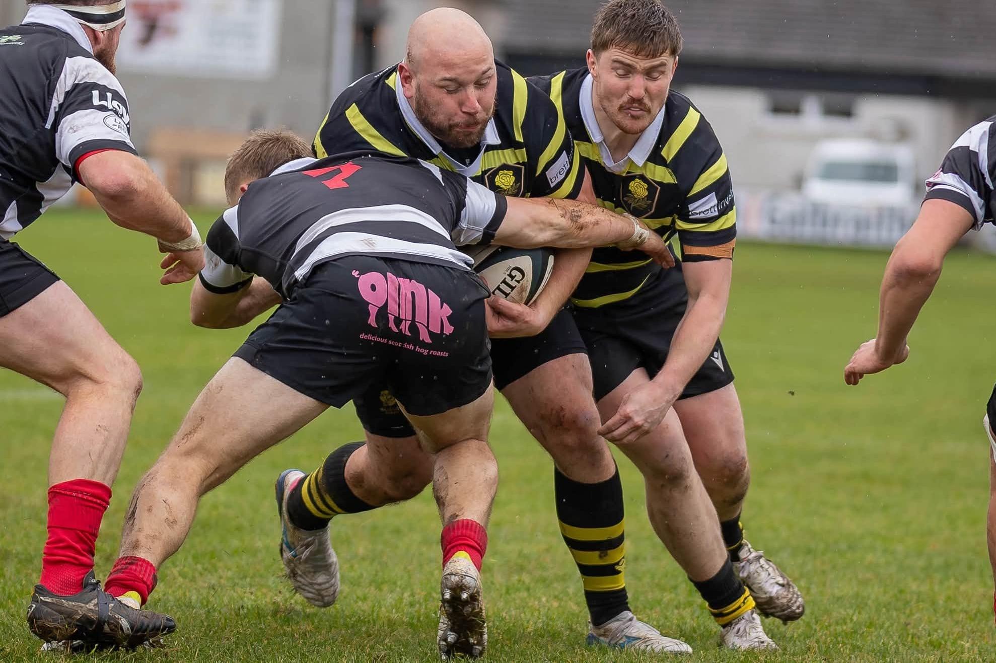 Tighthead prop Zen Szwagrzak on the ball for Melrose, with Craig Fairbairn supporting and Max Cranston tackling, as they lost 39-22 away to Kelso at Poynder Park on Saturday (Photo: Andy McLean)